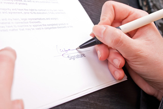 finances and policies image - a ladie's hand signing paperwork