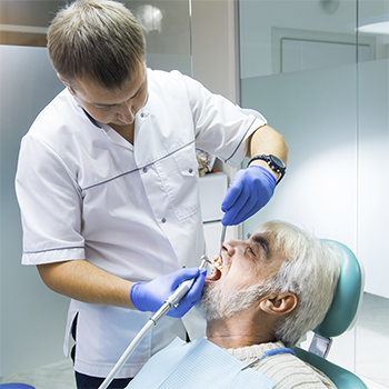 dentist with elderly patient during dental consultation